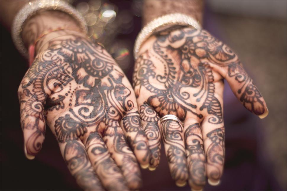 Free Image of Intricate henna tattoo designs on hands 