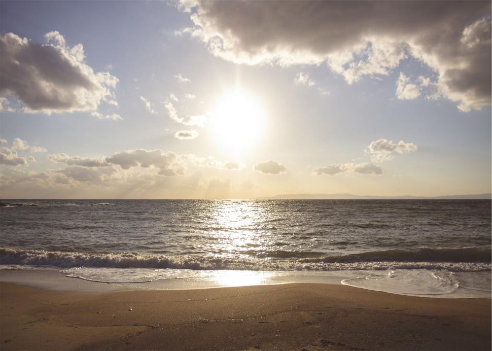 Free Image of Sandy beach with sunset and calm waves 