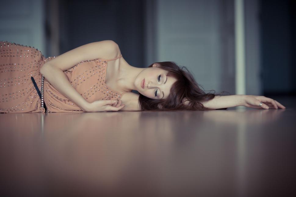 Free Image of Woman in an elegant dress lying on floor 
