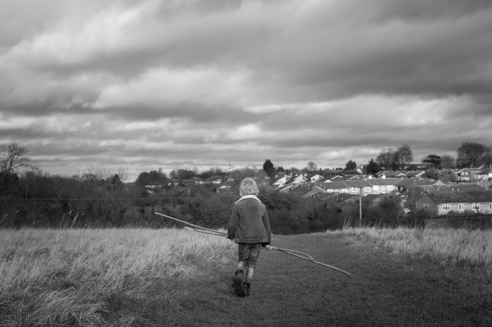 Free Image of Child walking in a countryside field 