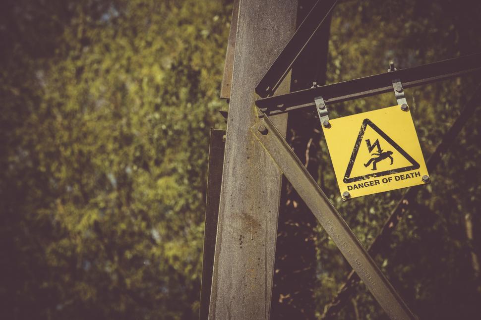 Free Image of Warning sign attached to wooden pole 