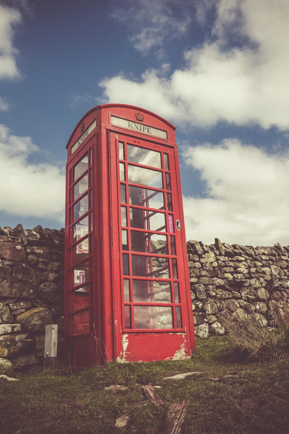 Free Image of Vintage red telephone box in rural setting 