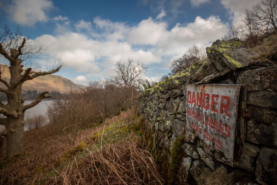 Free Image of Danger sign by a lake in the countryside 