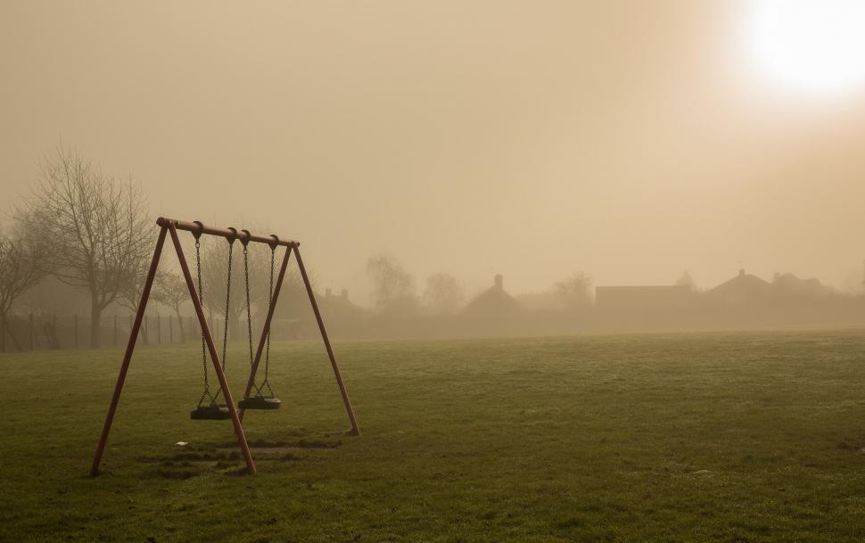 Free Image of Misty playground with swing set and houses 