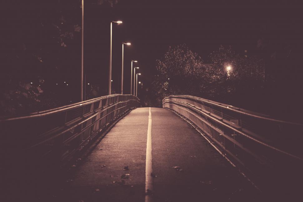 Free Image of Dimly lit pedestrian bridge at night 