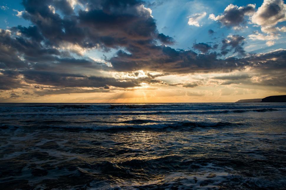 Free Image of Sunset sky over a turbulent sea 