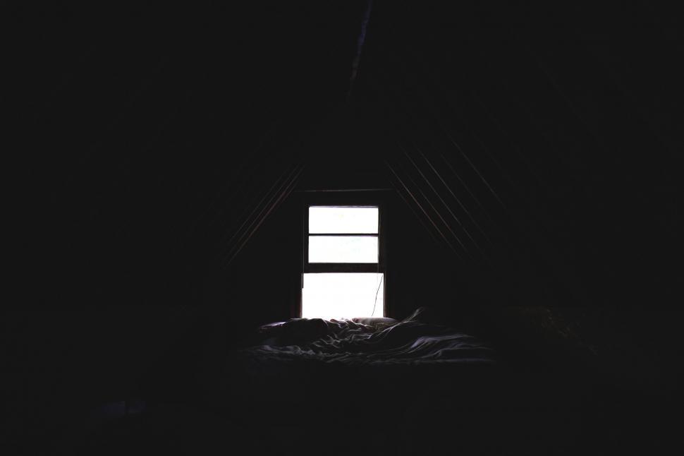 Free Image of Contrast of light in a dark attic room 