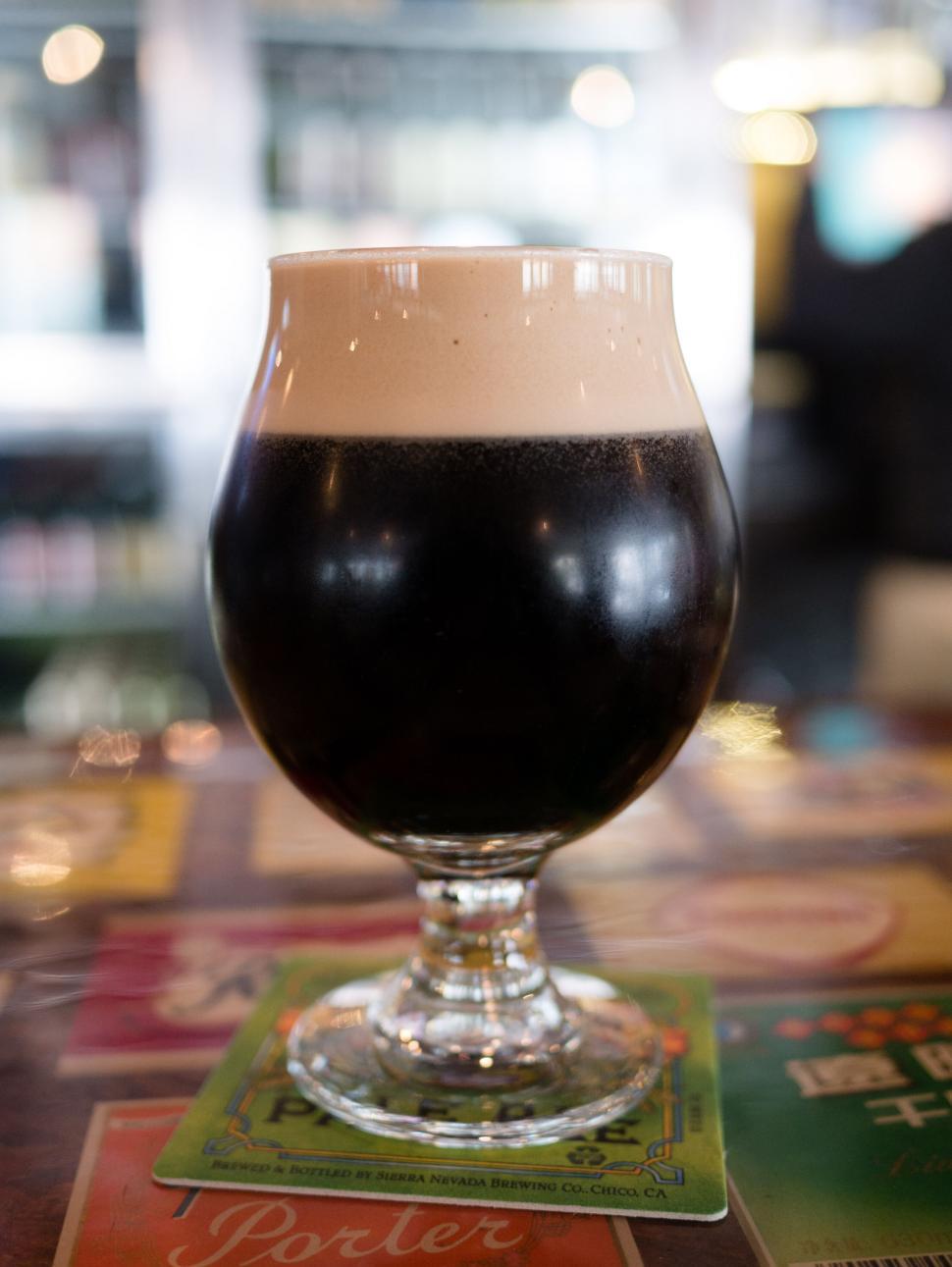 Free Image of Dark beer in glass on coaster 
