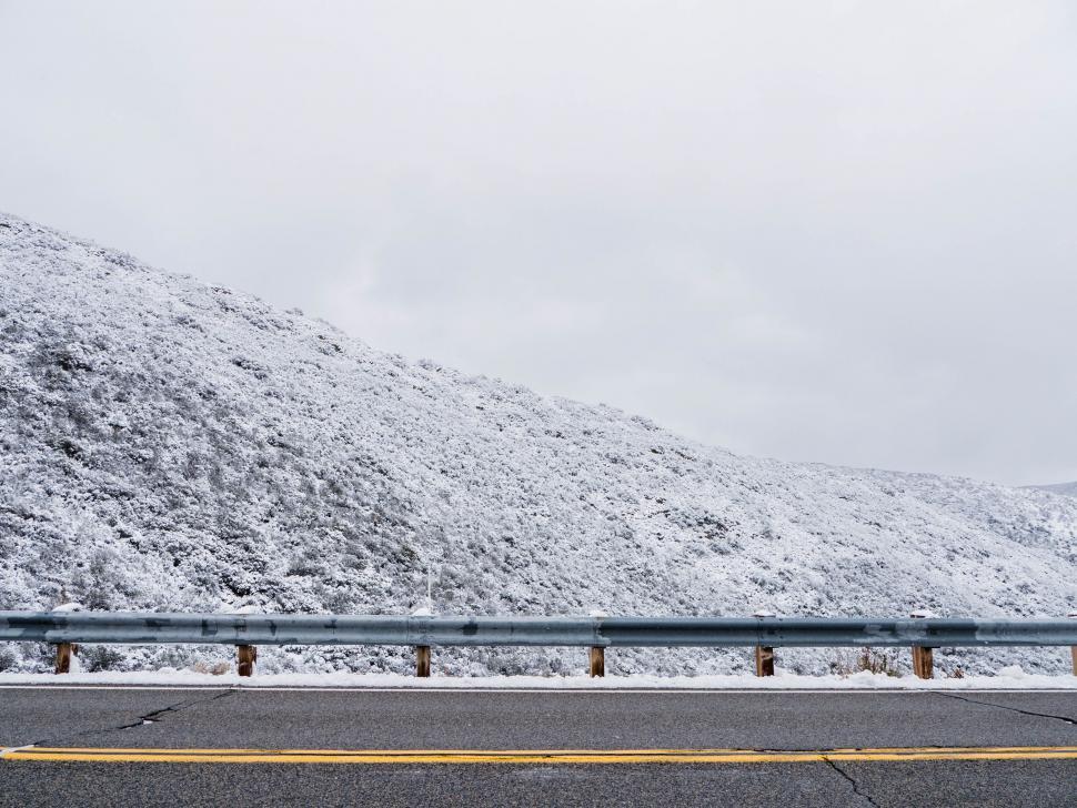 Free Image of Snowy hillside beside a road 