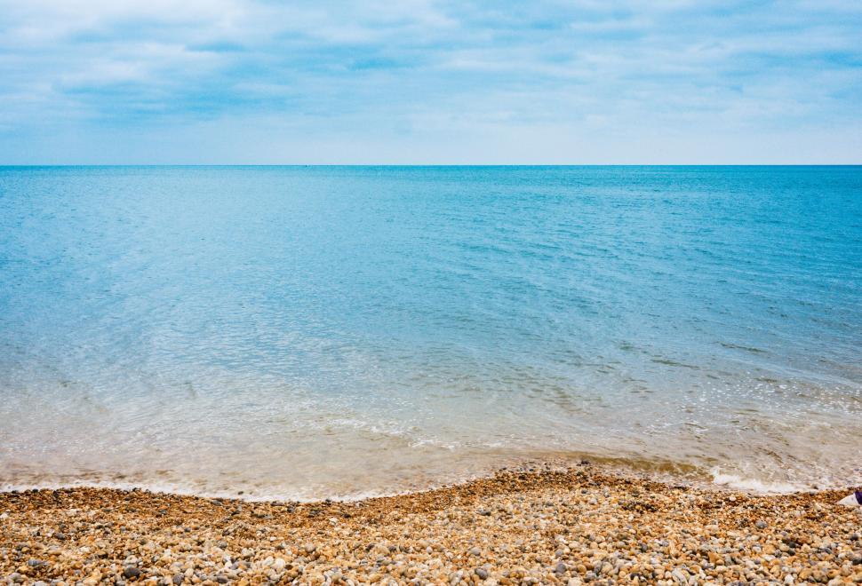 Free Image of Peaceful pebble beach and calm sea view 