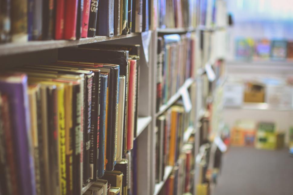 Free Image of Blurry Bookshelf in a Library Setting 
