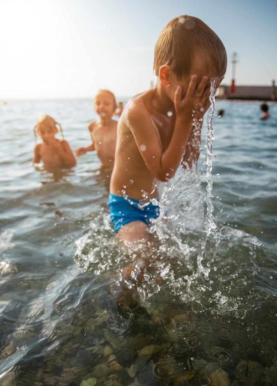 Free Image of Child splashing water in the sea 