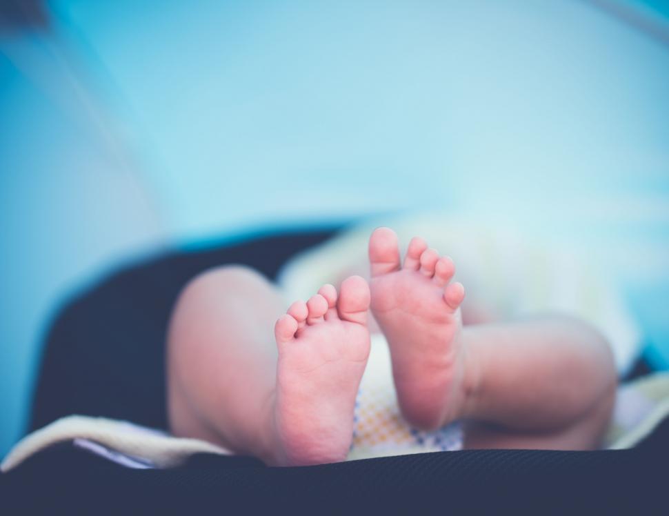 Free Image of Baby feet close-up on soft blanket 