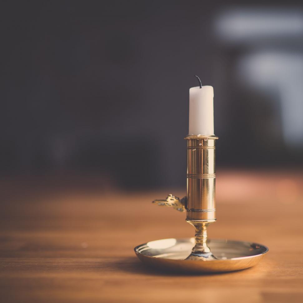 Free Image of Extinguished candle on brass holder 