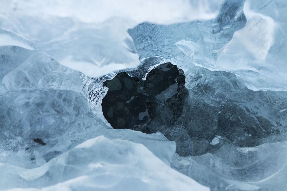 Free Image of Close-up of a heart-shaped hole in ice 
