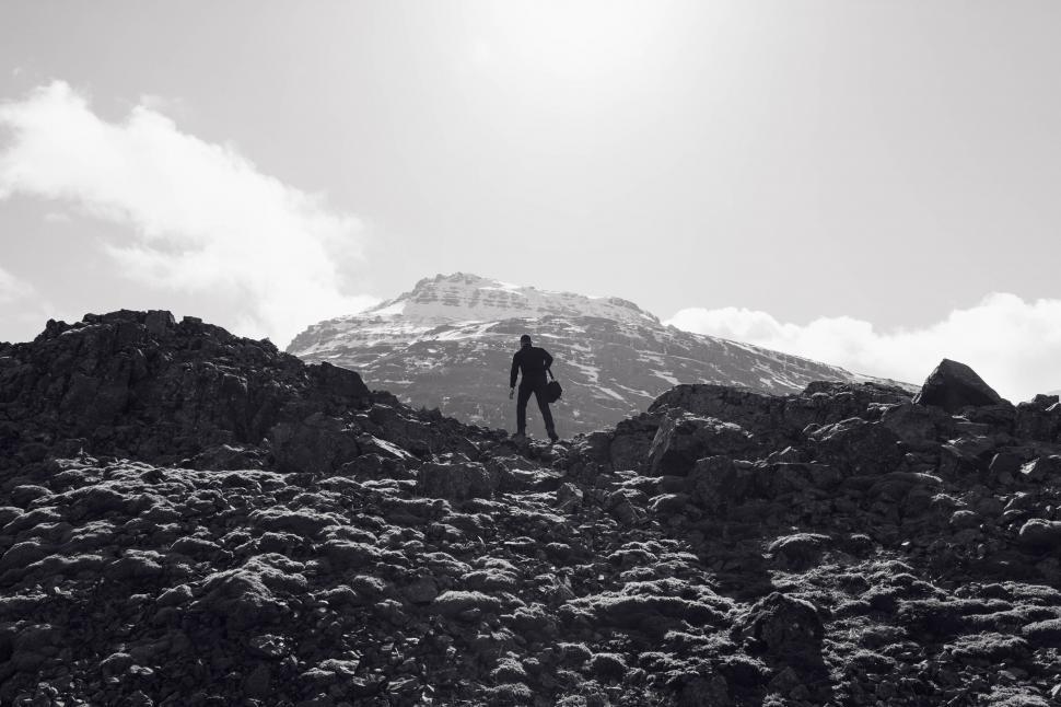 Free Image of Hiker ascending a rocky mountain landscape 