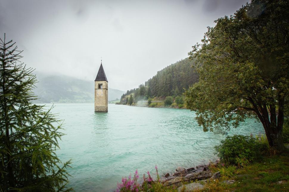 Free Image of Church tower in a lake with foggy backdrop 