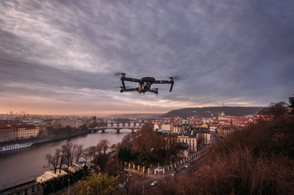 Free Image of Drone flying over city at dusk 