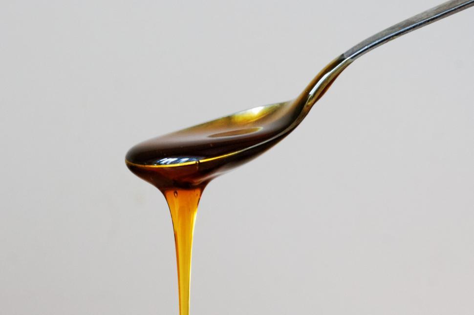 Free Image of Honey dripping from spoon close-up 