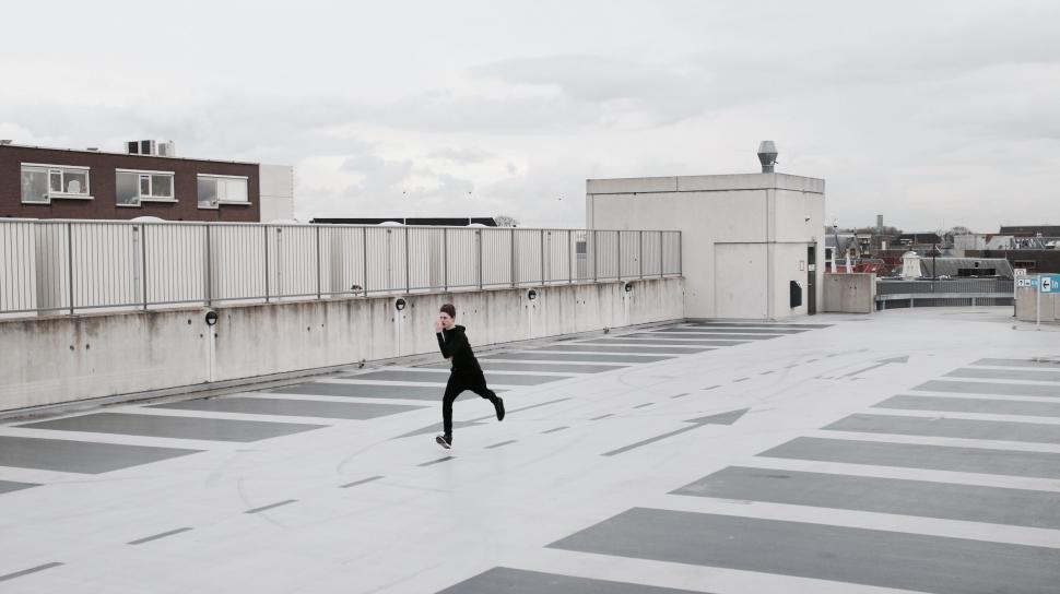 Free Image of Person dancing alone on rooftop 