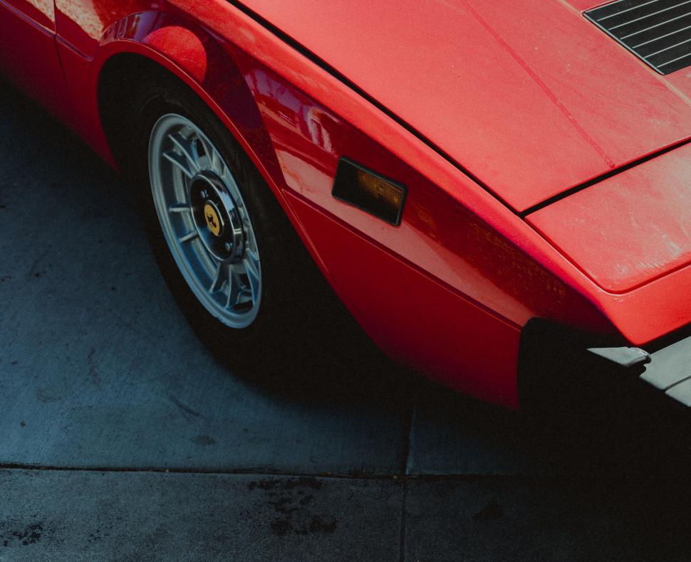 Free Image of Close-up of red vintage sports car 