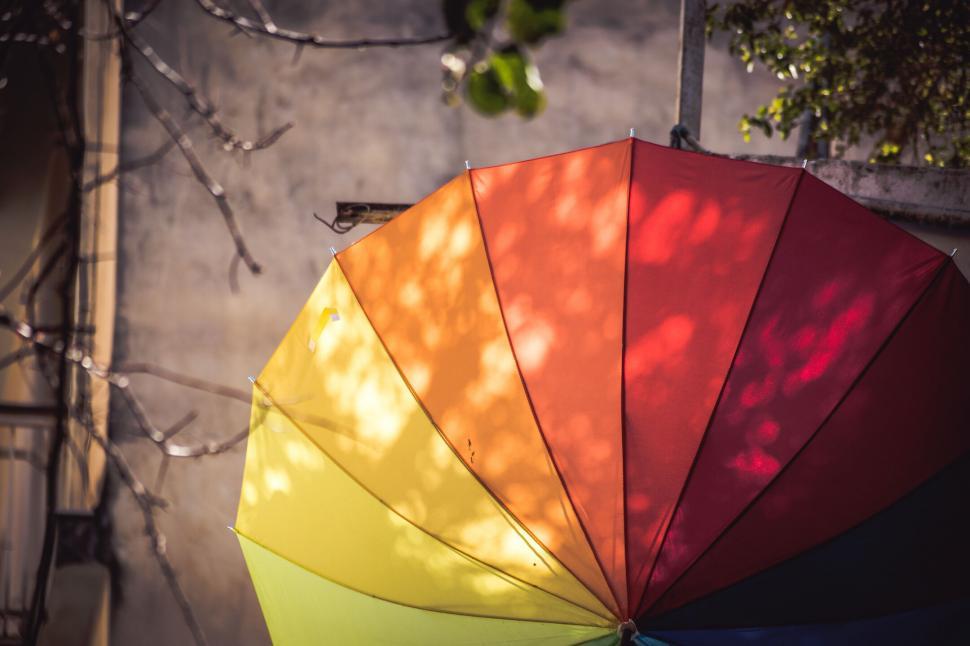 Free Image of Colorful umbrella against a building 