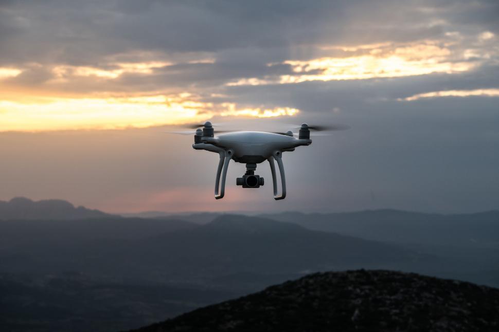 Free Image of Drone hovering in dramatic dusk sky 