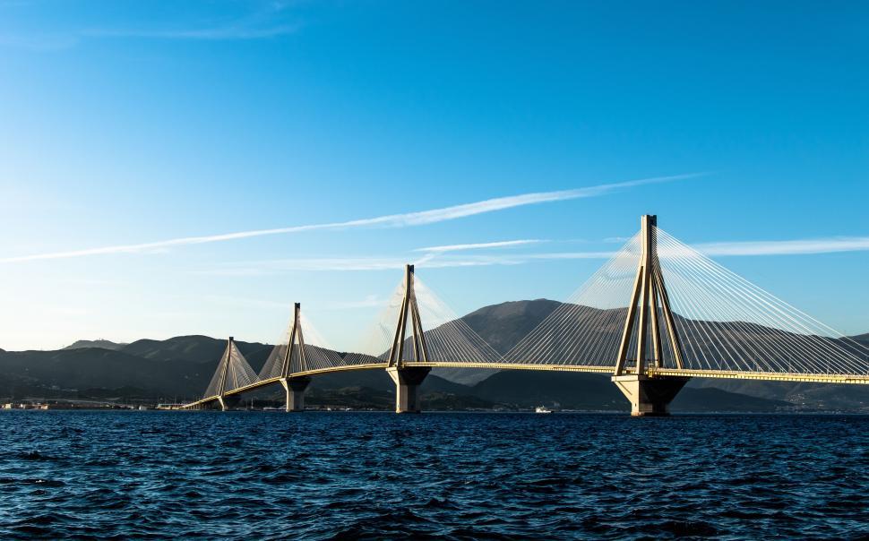 Free Image of Calm sea with a modern suspension bridge 