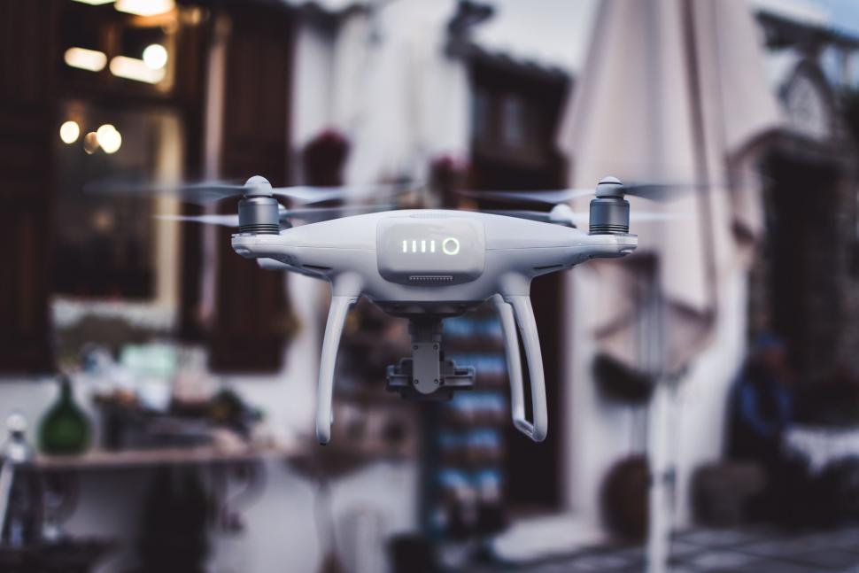Free Image of Camera drone hovering in urban outdoor setting 