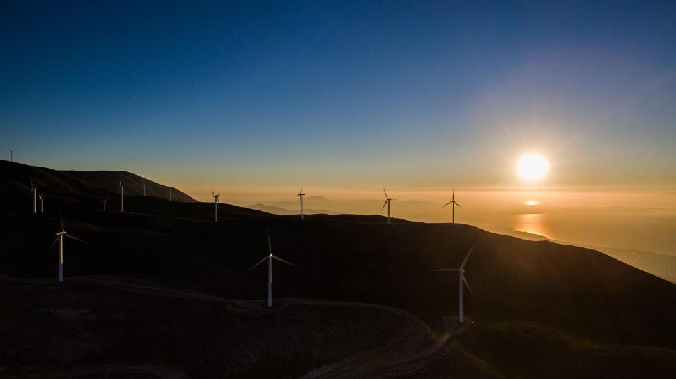 Free Image of Wind farm at sunset with ocean view 