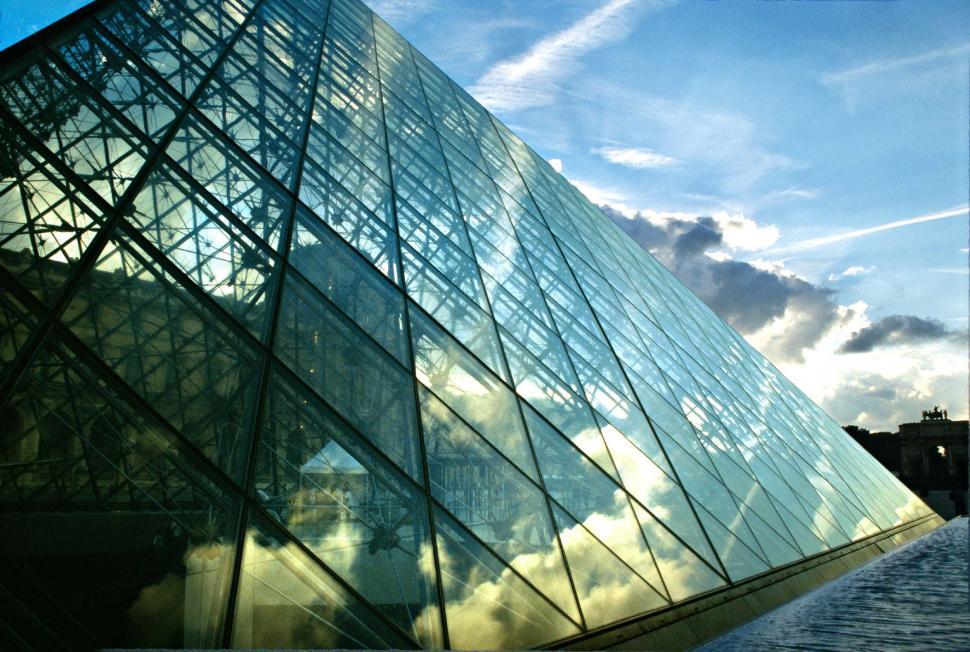 Free Image of Tall Glass Building Against Sky 