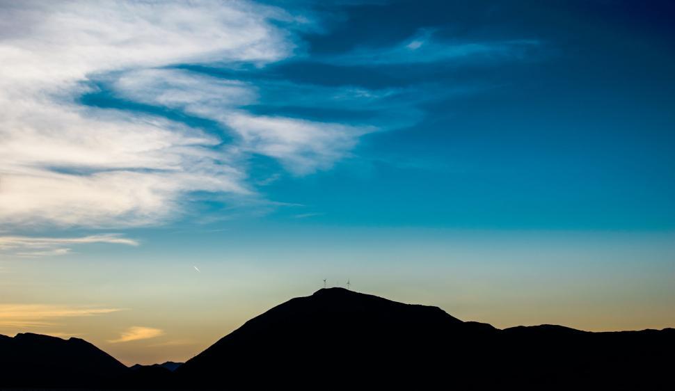Free Image of Silhouette of a hill with wind turbines at dusk 