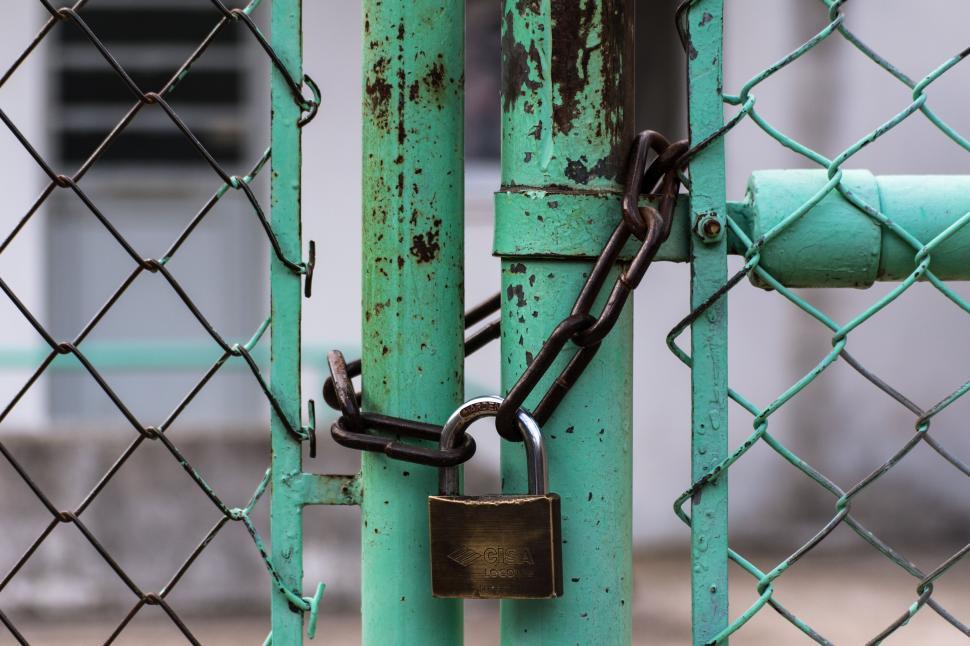 Free Image of Locked green gate with rusty chain and padlock 
