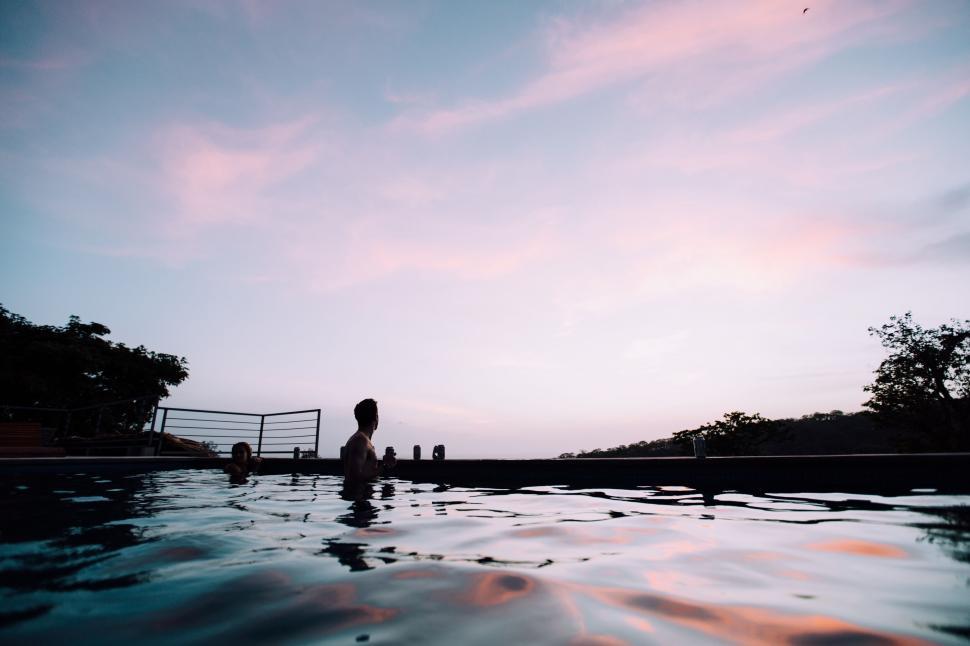 Free Image of Silhouette of a person in a pool at dusk 