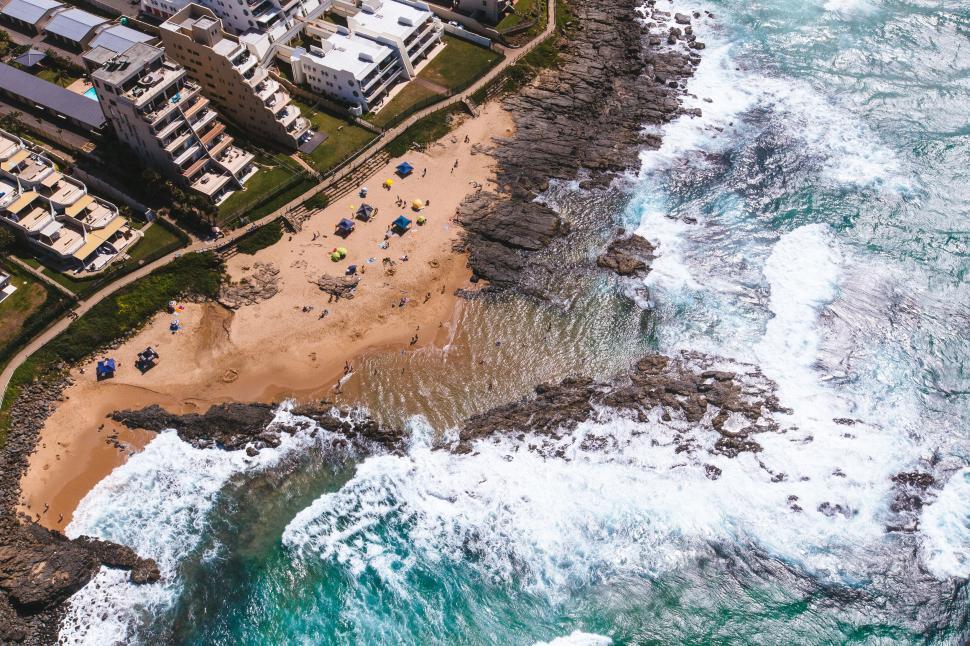 Free Image of Aerial beach shot with waves crashing 