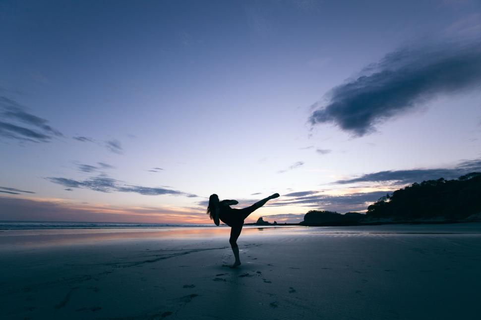 Free Image of Silhouette of a person dancing at sunset 