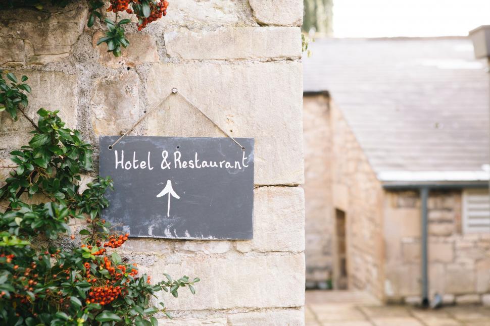 Free Image of Hotel and restaurant sign with arrow 