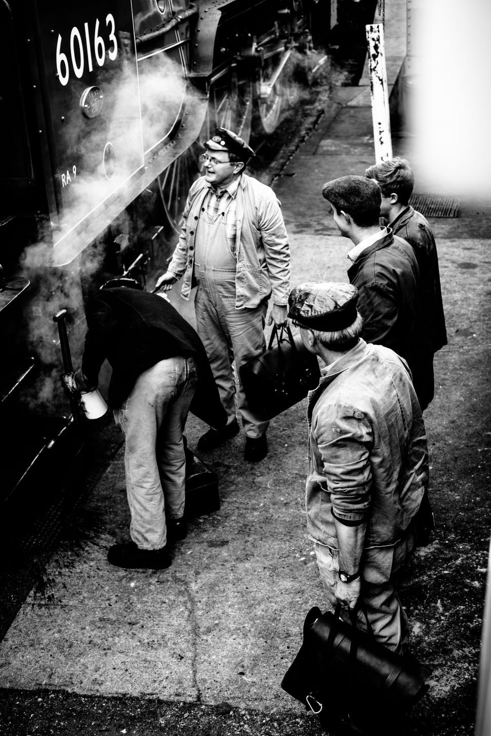 Free Image of Train station crew working on locomotive 