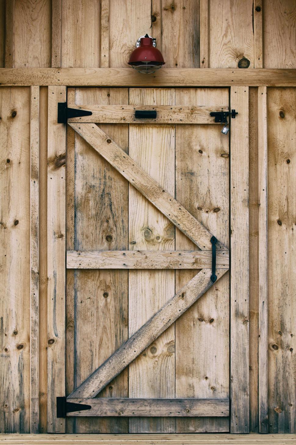 Free Image of Wooden barn door with vintage red lantern 