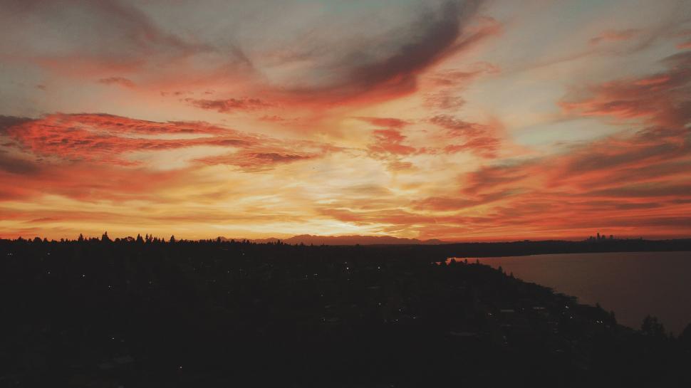 Free Image of Fiery sunset over a waterfront town 