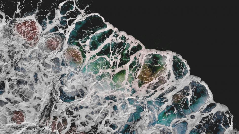 Free Image of Aerial view of foamy ocean waves 