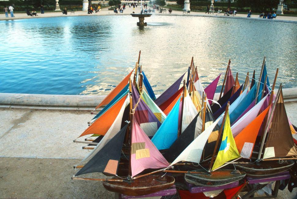 Free Image of Row of Colorful Sail Boats in Front of Fountain 