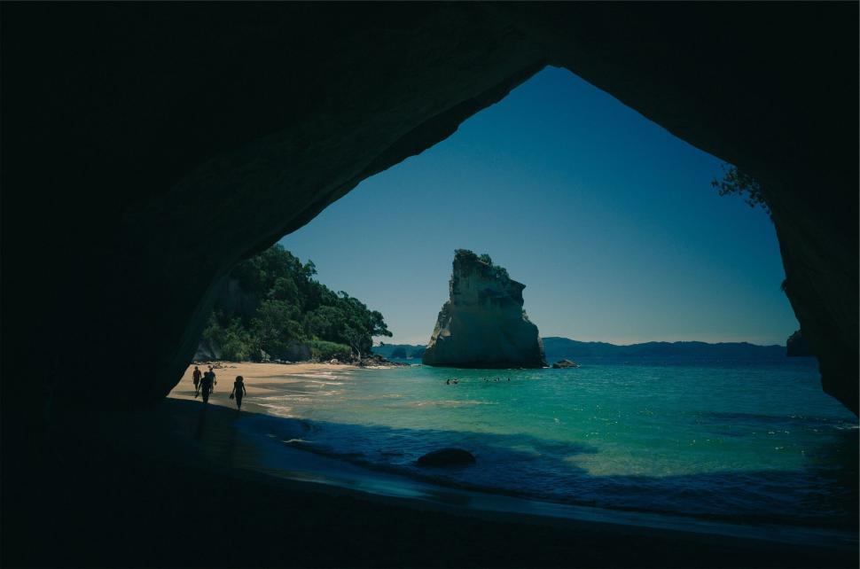 Free Image of Beach cave with people and rock formations 