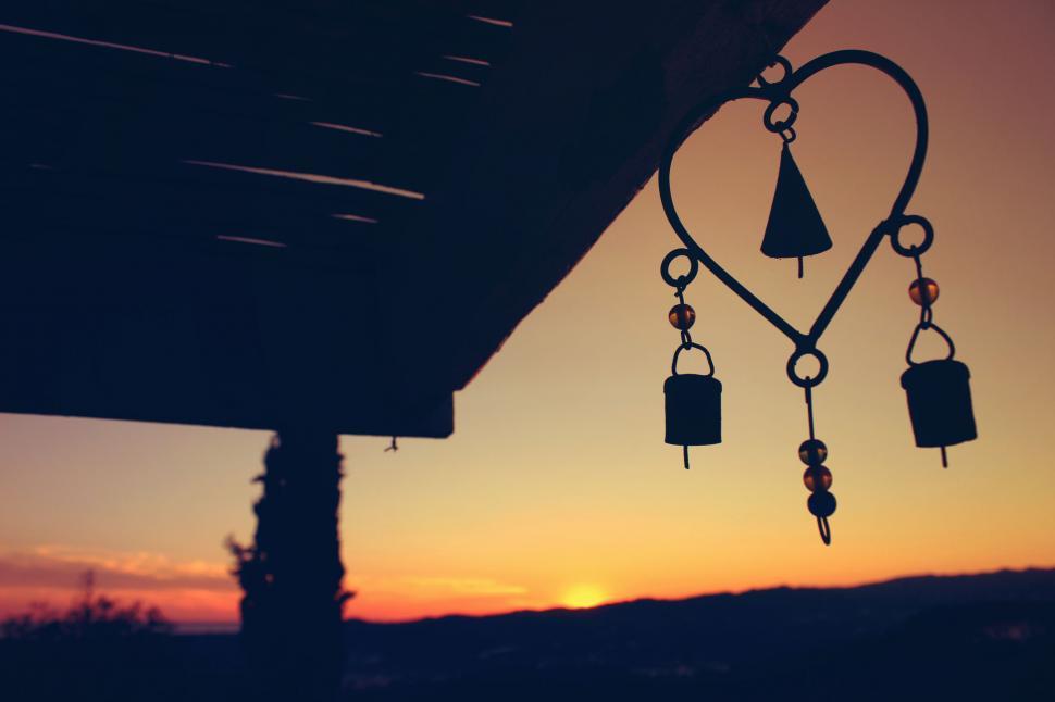 Free Image of Wind chime silhouette at sunset 