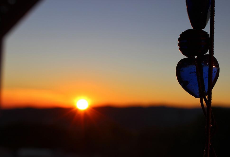 Free Image of Sunset view through a heart-shaped object 