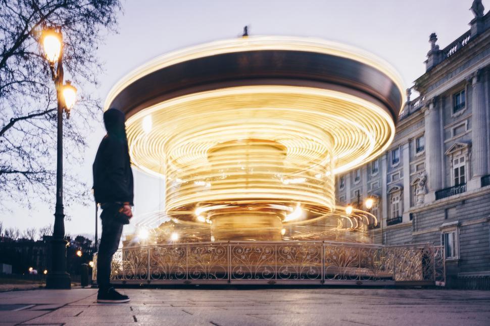 Free Image of Blurry carousel and a person in motion 