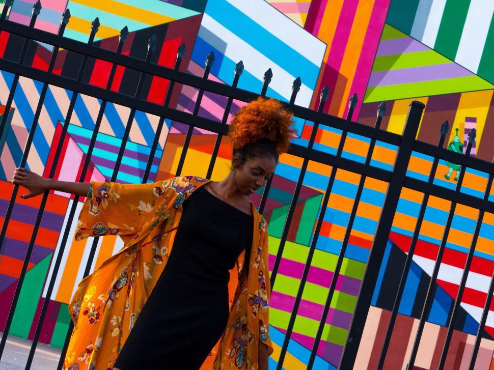 Free Image of Person in front of colorful geometric mural 