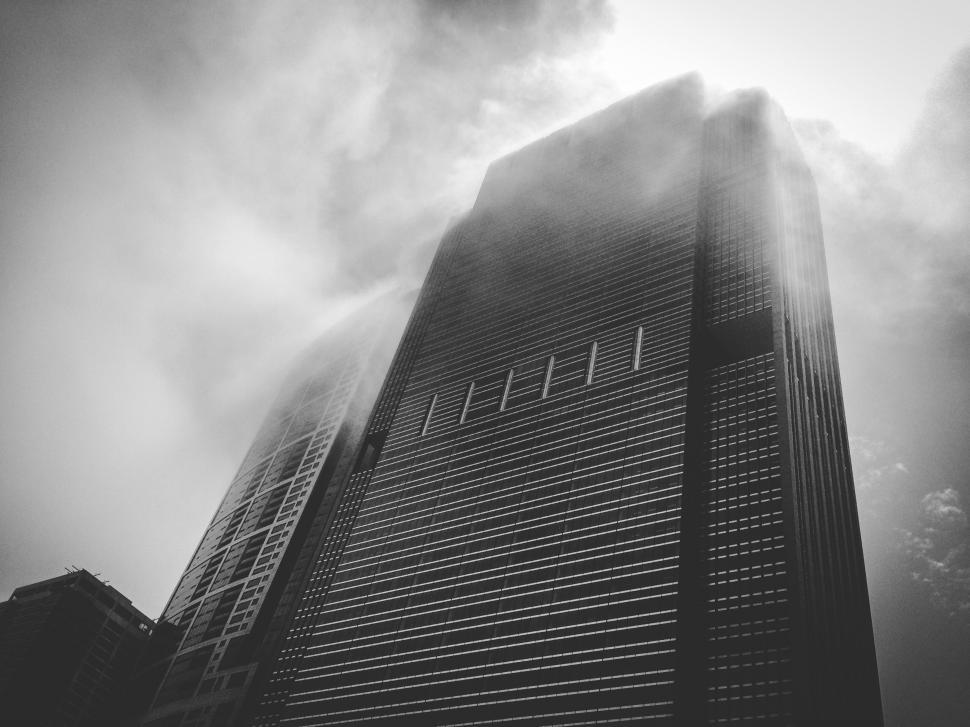 Free Image of Skyscraper shrouded in misty clouds 