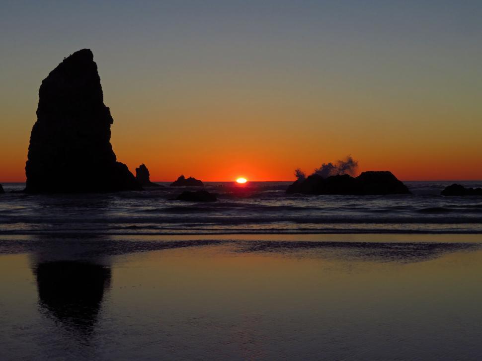 Free Image of Sunset beach scene with sea stacks and waves 
