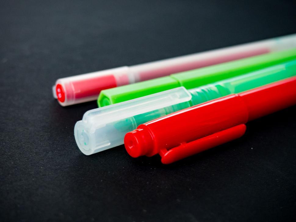 Free Image of Close-up of colorful markers on dark background 